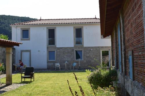 a person sitting in a chair in front of a house at Casa Zinda in Candemil