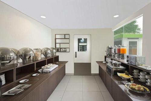 a large kitchen with a buffet line in a restaurant at IXO Bekasi in Bulanbulan