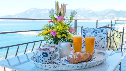 a table with a breakfast of coffee and croissants and orange juice at B&B Tramonto Sul Mare in Salerno