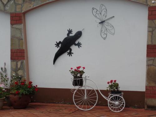 a white wall with a lizard and a bike on it at Villa Leone Boutique Hotel in Nairobi