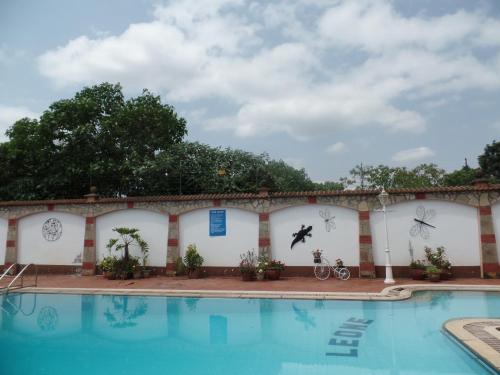 a building with a swimming pool in front of it at Villa Leone Boutique Hotel in Nairobi