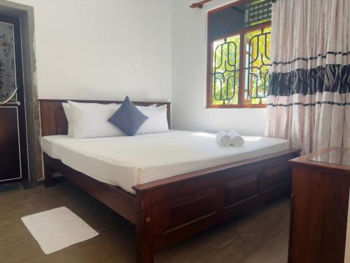 a bed in a room with a stained glass window at Viska Villa 2 Bedroom Home 5 min to Hiriketiya in Nilwella
