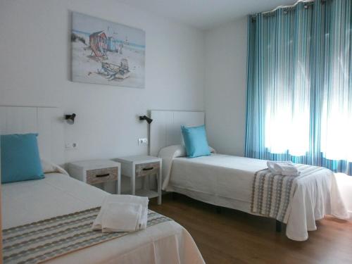 Postel nebo postele na pokoji v ubytování La Siesta Apartamentos