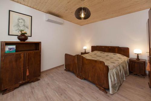 a bedroom with a bed and two night stands and two lamps at Holiday Home NiKa in Omišalj