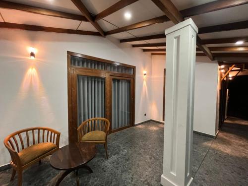 a room with two chairs and a table at Cashew Garden Resort & Restaurant in Dambulla