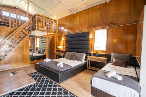 a bedroom with two beds and a staircase at simlarda aquapark otel in Ayvalık