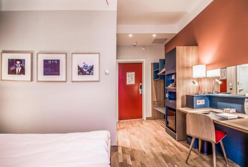 a hotel room with a bed and a desk at Hotell Bondeheimen in Oslo
