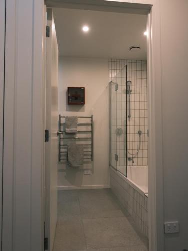 a bathroom with a shower and a walk in shower at The Petone Beauty - Flash, Beachside in Lower Hutt