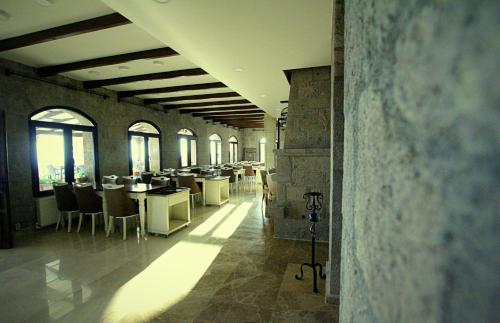 a room with tables and chairs in a building at Assos Sunaba Kasri Hotel in Behramkale