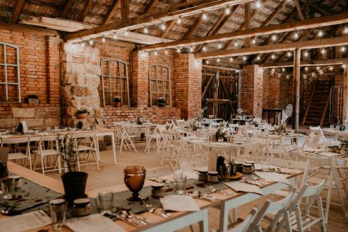a large room with tables and chairs in it at Hamerský mlýn 