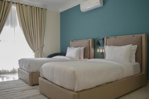 Ένα ή περισσότερα κρεβάτια σε δωμάτιο στο Zhule by Roomy, Skardu