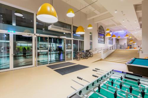 a gym with a pool table in a building at a&o Salzburg Hauptbahnhof in Salzburg