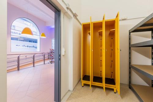 a locker room with yellow doors in a store at a&o Salzburg Hauptbahnhof in Salzburg