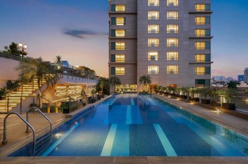 a large swimming pool in front of a building at JW Marriott Hotel & Suites Saigon, The Apartments in Ho Chi Minh City