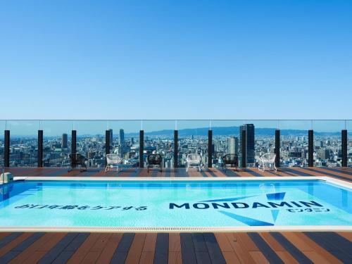 a swimming pool on the roof of a building with a view at APA Hotel & Resort Osaka Namba Ekimae Tower in Osaka