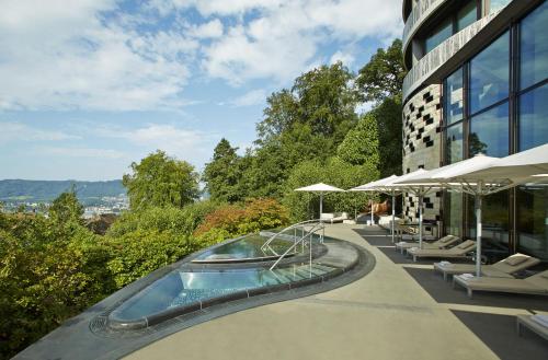 a swimming pool on the side of a building at The Dolder Grand - City and Spa Resort Zurich in Zurich