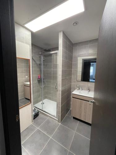 a bathroom with a shower and a tub and a sink at Bord de mer in Sainte-Maxime