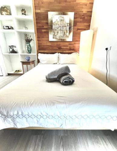 a bedroom with a large white bed with a hat on it at Salisbury Suburban Escape in Brisbane
