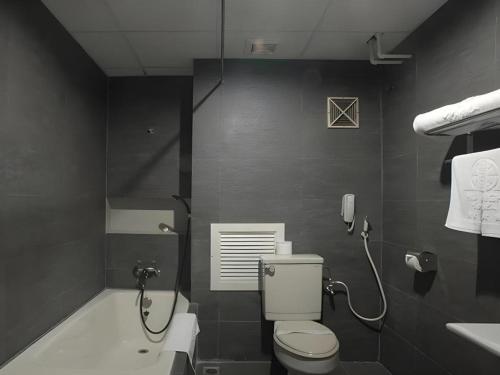 a bathroom with a toilet and a shower and a sink at Huu Nghi Hotel in Hai Phong