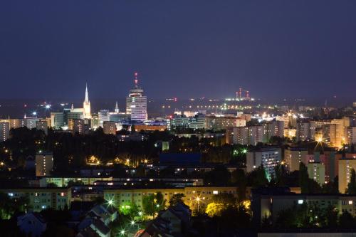 a city skyline at night with lit up buildings at Apartments IN - Bandurskiego in Szczecin