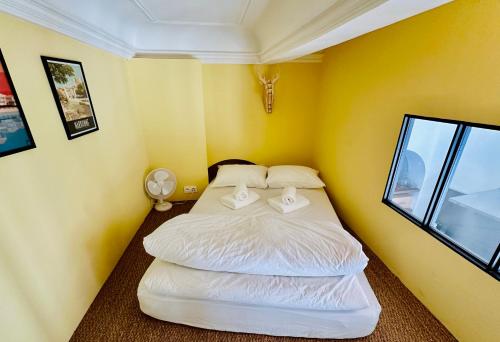 a small room with two beds in it with a window at Puddington Abbey by Art&Suites Élégant XVIIIe 80m privatif Centre ville Calme et douceur de vivre in Narbonne