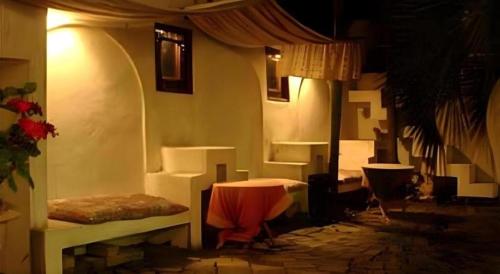 a room with a bed and a table in it at Arabian Art Hotel & Gallery in Kawaguchi