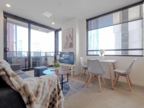 a living room with a couch and a table at High level on 42th floor 2BR 1BA Balcony Pool in Melbourne