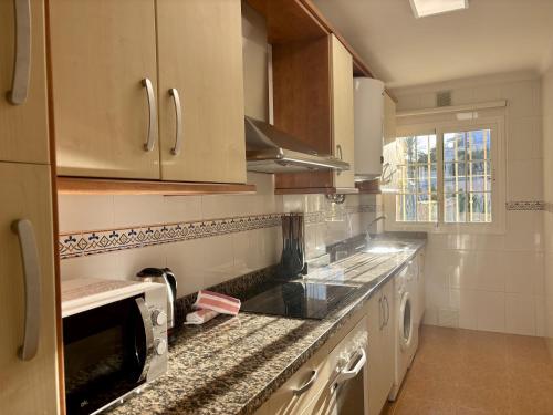 a kitchen with a sink and a counter top at Apartamento Adelfa By Solymar Holiday in Benajarafe