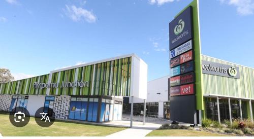 a building with a sign in front of it at Comfortable Home stay in Pimpama
