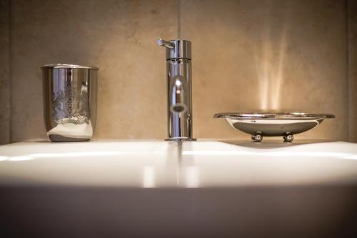 a bathroom sink with a faucet and a bowl at La Casa di Ele in Matera