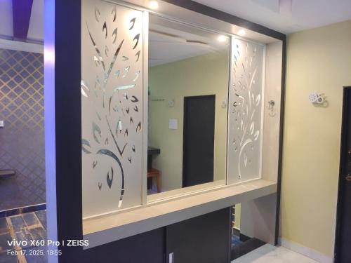 a bathroom with a mirror with birds on it at bangalore residency in Srikalahasti