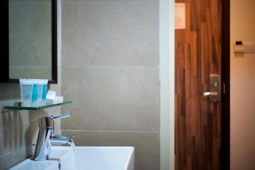 a bathroom with a sink and a mirror at Value Hotel Thomson in Singapore