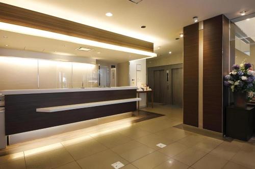 a lobby with a reception desk in a building at Nagoya Fushimi Montblanc Hotel in Nagoya