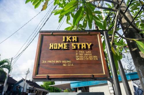 a sign for ahmhm home stay on a street at Ika Homestay 2 in Canggu