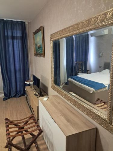 a bedroom with a bed and a large mirror at TES Flora Apartments in Borovets