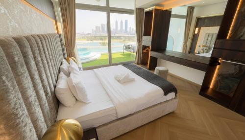 ドバイにあるHighend Azure 1BR Sea View and Private Beach with Pool Accessの大きな窓のあるベッドのある寝室