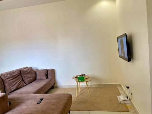 a living room with a couch and a table at Studio equipped to your liking in Dakar