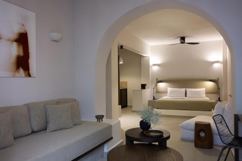 a living room with a bed and a couch at Bellonias Villas in Kamari
