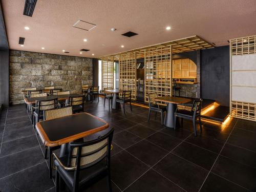 a restaurant with tables and chairs in a room at Hakone Hibarino in Hakone