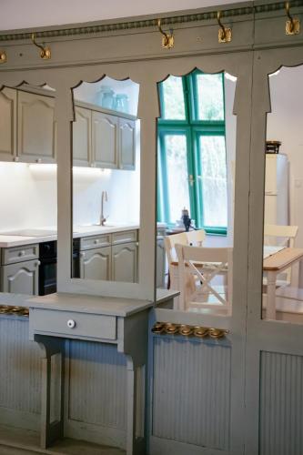 a kitchen with white cabinets and a counter top at Nostalgia in Turda