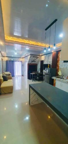 a living room with a table in the middle of a room at Vel Serene Villa in Panglao Island
