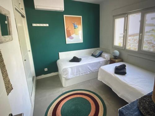 サン・ホセにあるBeachfront apartamento in san joséの緑の壁の客室で、ベッド2台が備わります。