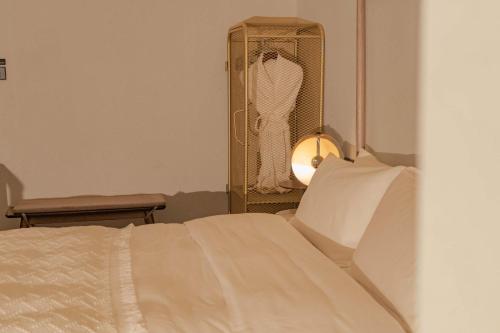 a bedroom with a bed and a dresser with a closet at Dali Mountain and Lake View Hotel in Dali Shuanglang