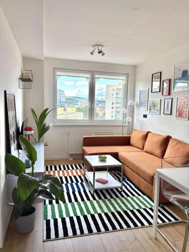 a living room with a couch and a table at Krivoo Apartments III in Košice