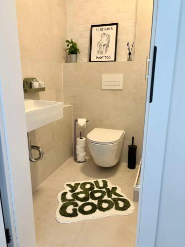 a bathroom with a toilet and a rug at Krivoo Apartments III in Košice