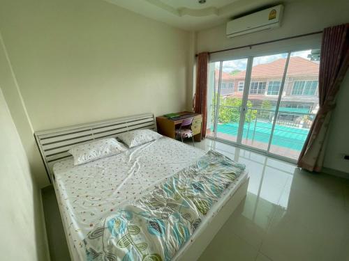a bedroom with a bed with a view of a pool at Cozy House in the center of Khon Kaen in Khon Kaen