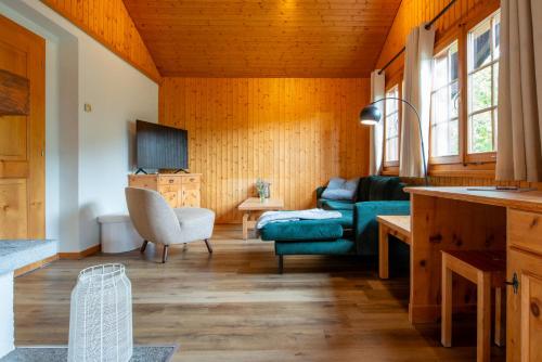 a living room with a couch and a table at Chalet Mon Reve in Blitzingen