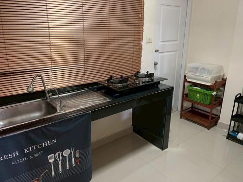 a kitchen with a sink and a counter top at Cozy House in the center of Khon Kaen in Khon Kaen