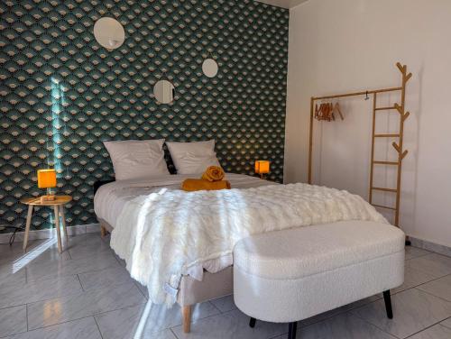 a teddy bear sitting on a bed in a bedroom at Studio avec jardin et parking in Chartres