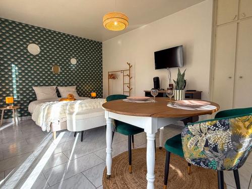 a bedroom with a bed and a table and a table and chairs at Studio avec jardin et parking in Chartres